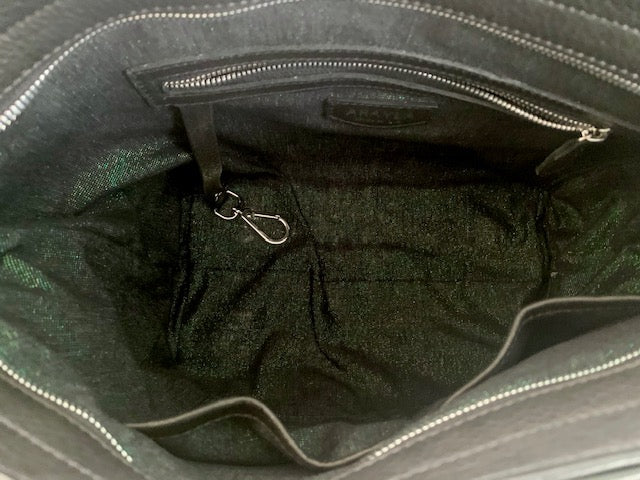 Close-up of the onyx black leather bag interior with a zip pocket, key leash, and two slip mobile pockets.