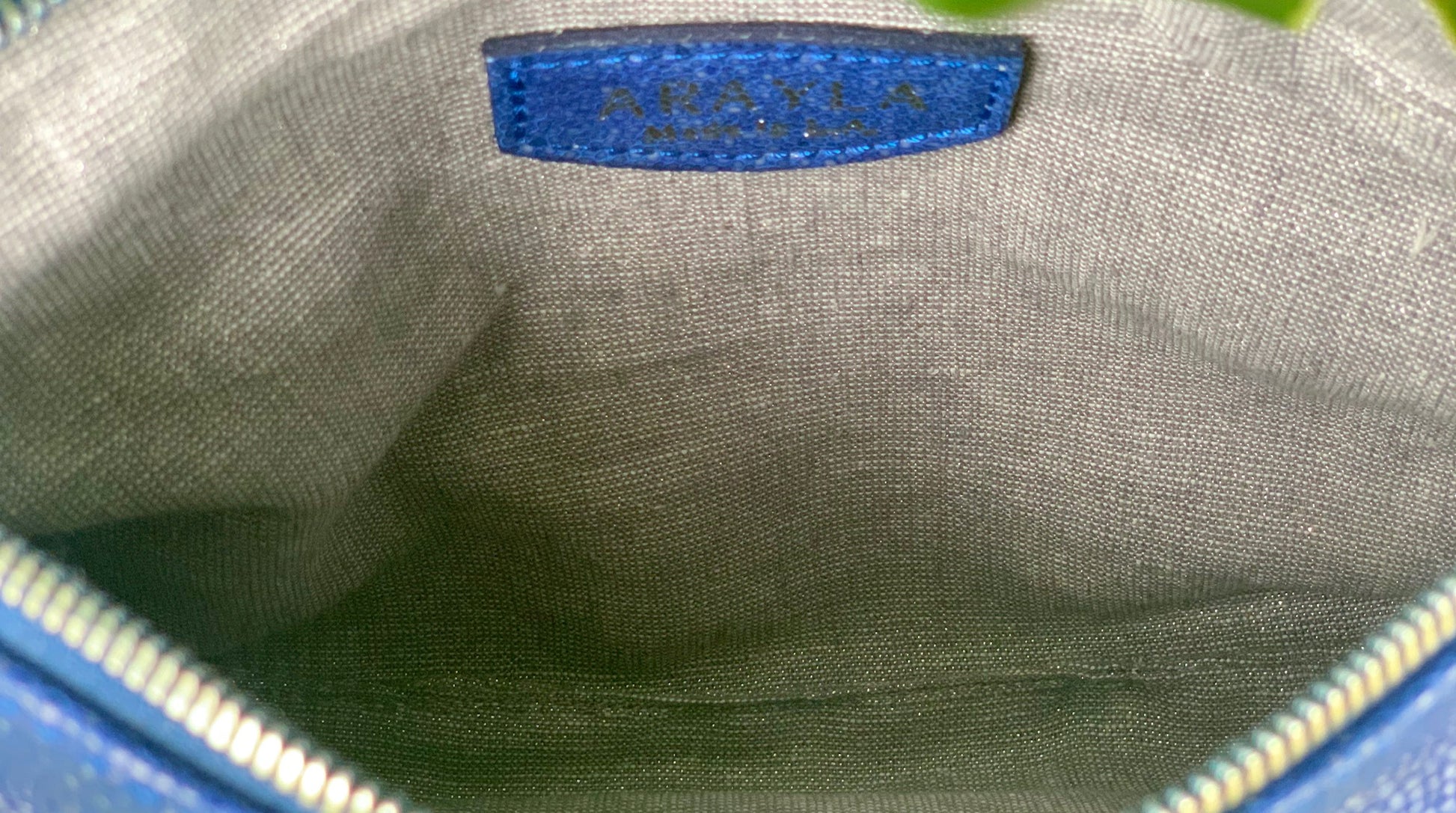 Close-up of the ehukai blue stingray embossed leather interior with a visible brand logo on a Silver grey metallic textile lining.
