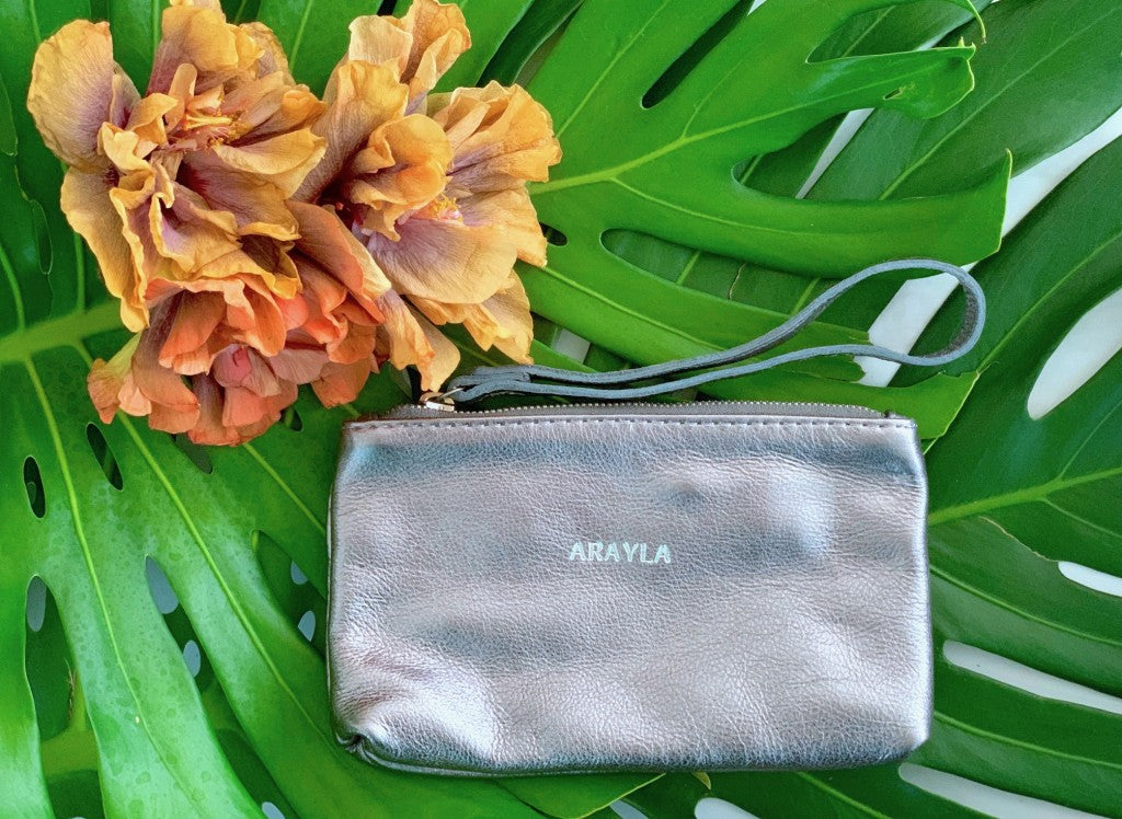 Mini Clutch In Pewter Metallic Butter Leather with 'ARAYLA' branding on green leaves
