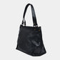 Onyx black butter leather bag on a light gray background