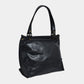 Onyx black butter leather bag on a light gray background