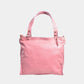 Rose Quartz Butter Leather bag on a light gray background