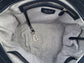 Close-up of the sapphire leather satchel bag interior with silver grey shimmer textile lining, key leash, zip pocket, two slip mobile pockets and sunglasses pocket.