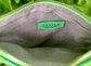 Close-up of the mermaid green stingray embossed leather interior with a visible brand logo on a Silver grey metallic textile lining.
