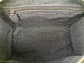 Close-up of the titanium gray leather bag  interior with a visible brand logo on a Silver black textile lining, zip pocket, and two slip mobile pockets.


