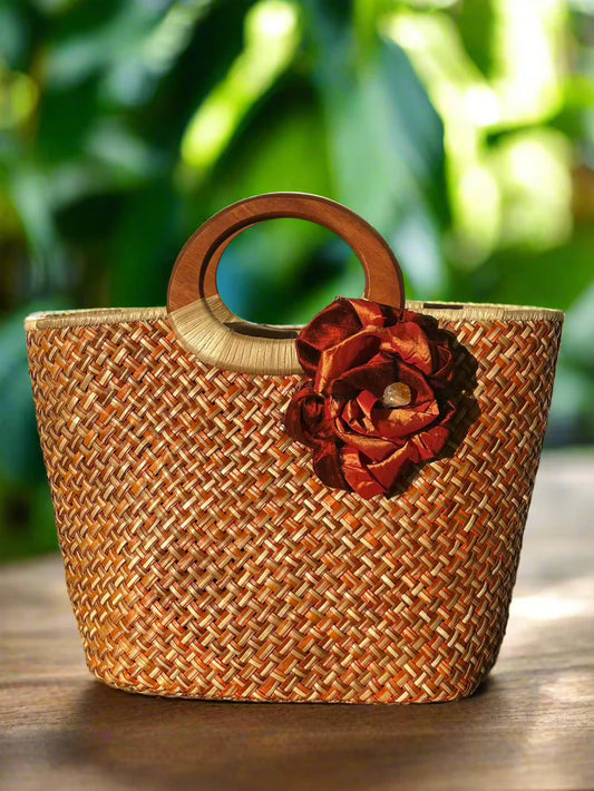 Handwoven Lauhala handbag with wooden handle and an Artisan-crafted silk flower with  
Raw citrine gemstone in the center.