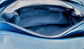 Close-up on the demin blue handbag inside view with a zip pocket.