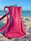 Hibiscus Pink bag side view on a sandy beach with ocean in the background